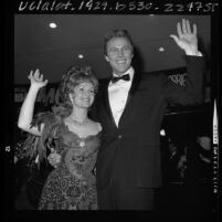 Debbie Reynolds and Harve Preshell waving to fans at premier "The Unsinkable Molly Brown" in Los Angeles, Calif., 1964