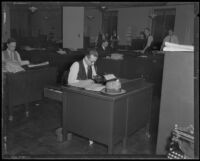 Los Angeles Times reporter Chester L. Hale at his desk, Los Angeles, 1935