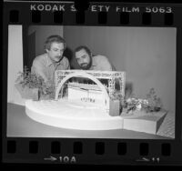 Frank O. Gehry and Peter Wexler inspecting model for redesign of Hollywood Bowl, Calif., 1976