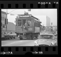 Red Car trolley on wheels driving down Green Street in Pasadena, Calif., 1974