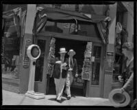 Roy Watkins, who worked for the Angelus Temple, and Everett Davis exit a store, 1932