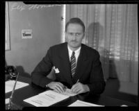 Rex Thomson sits at his desk, Los Angeles, 1934