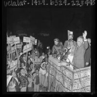 Barry Goldwater with family waving to crowd at Lockheed Air Terminal during presidential campaign in Burbank, Calif., 1964