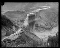 Downward view towards the remaining center portion of the St. Francis Dam after its disastrous collapse, San Francisquito Canyon (Calif.), 1928