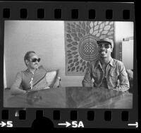 Musician Stevie Wonder with music executive Ewart Abner in Los Angeles, Calif., 1975