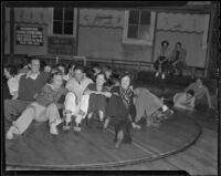 Young adults on spinning floor ride at Venice Beach fun house, Los Angeles, 1936