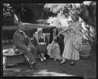 Bishop W. Bertrand Stevens, Mrs. Stevens, and Mrs. Moore admire Shirley Wells in the gardens, Bel-Air, 1935