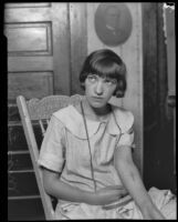 Miss Lilian "Lalla" Vennum, at home, shows cross "branded" on her arm, Los Angeles, 1926