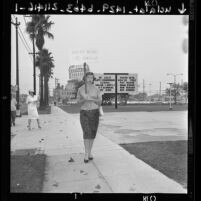 Woman picket protesting an anti-Communism school under way at the Los Angeles Sports Arena, 1961