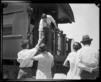 Crown Prince Gustav Adolf of Sweden shakes hands with an admirer from the back platform of his private car, Mojave Desert, 1926