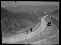 Three men explore the site of a murder on Montecito Drive, Los Angeles, 1922