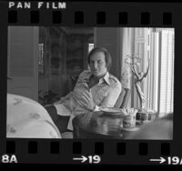 Film and television producer, Jerry Weintraub at home with his Emmy Award in Los Angeles, Calif., 1975