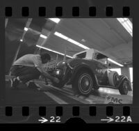 George Adelsperger inspecting Model T Roadster at emission inspection station in Calif., 1975