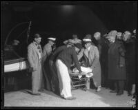 George Young brought ashore after swimming across Catalina Channel at Point Vicente, Los Angeles, 1927