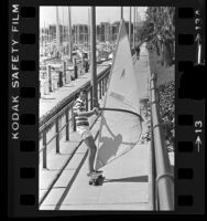 Hans Dose wind surfing on skateboard at Long Beach Marina, Calif., 1978