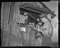 Darrel Lacy, Bert Burbank Jr., and James Maizes of the Sons of the American Legion use a radio to assist firefighters, Los Angeles, 1938