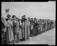 Spectators watching the Santa Anita Handicap race from behind a fence, Arcadia, 1936