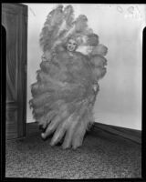 Fan dancer Joyce Baker surrounded by feathers, 1935