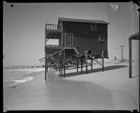 Beach house threatened by tide, Newport Beach, 1933