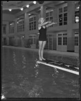 Dorothy Poynton, Olympic diver, posing in a backward dive start position, 1932