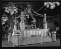 Dorothy Isaac stands on the Redlands display at the National Orange Show, San Bernardino, 1934