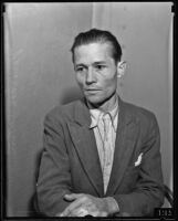 Vernon John sits in a police station accused of bigamy, Los Angeles, 1935