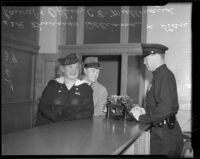 Officer Eugene C. Mullenaux with Vera Shuvalova and Stan Laurel before Vera serves her jail sentence, Beverly Hills, 1939