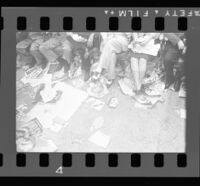 Delegates at the Democratic National Convention sit over posters for candidates strewn on the floor, Los Angeles, 1960