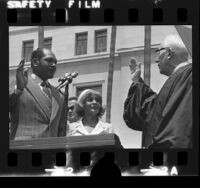 Tom Bradley, with wife Ethel, being sworn-in as mayor by Justice Earl Warren in Los Angeles, Calif., 1973