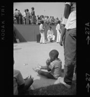 African American child waits for Watts Summer Festival to begin