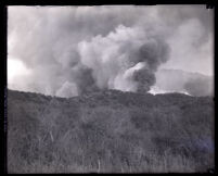 Plumes of smoke from wildfire rising from Decker Canyon, Los Angeles County, circa 1920