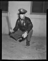 Patrolman Roy Mills searches for spiders to kill, Fullerton, 1936