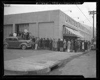 Long line of people waiting to obtain meat during first day of war rationing in Los Angeles, Calif., 1943