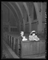 Marine Lt. Tom Bussjager with his wife and child alone in St. Michael Church praying in Los Angeles, Calif., 1945