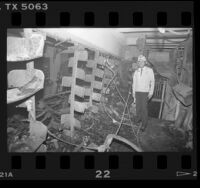 Deputy Fire Chief Don Anthony amongst stacks destroyed by fire at Los Angeles Central Library, 1986