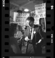 Ralph Nader talking with reporter during campaign for California Proposition 103, 1988