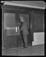 Asa Keyes, district attorney of Los Angeles County, at the closed door of the District Attorney office, 1923-1928