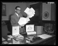 Los Angeles Mayor Poulson holds handfuls of letters and telegrams supporting stand against Soviet Premier Nikita Khrushchev, 1959