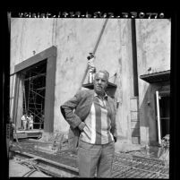 Mike Frankovich, head of Columbia Pictures standing amongst construction of new sound-stage in Los Angeles, Calif., 1965