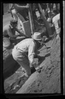 Workers attempt to rescue John M. Burns, Robert Rosenthal, and Bernard Glennin after a cave-in, Los Angeles, 1937