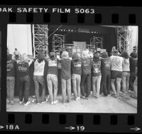 Line of heavy metal fans wearing concert t-shirts watching band on stage at Starlight Theater in Burbank, Calif., 1984