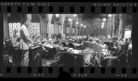 Mayor Tom Bradley speaking in city council chambers about proposed jobs cuts, panoramic, Los Angeles, Calif., 1978