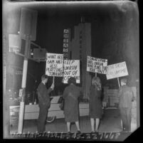 Four pickets at outside a Democratic Ball at Ambassador Hotel in Los Angeles, Calif, 1965