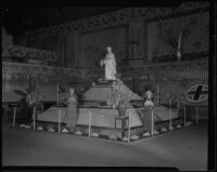 Two women stand in front of the Pomona display at the National Orange Show, San Bernarndino, 1935