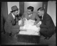 Los Angeles County sheriffs with trunk of baby clothes, Oildale, 1927