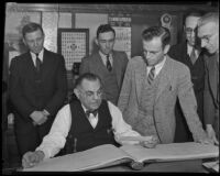 Herbert D. Alfonso looks over his ledger, Los Angeles, circa 1934