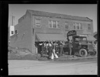 Men clearing mud from a street after a catastrophic mudslide, La Crescenta-Montrose, 1934