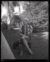 Millicent Sunday seated in a chair in a park or yard, Los Angeles, 1928