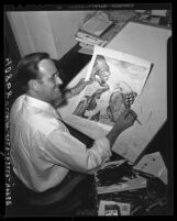 Bruce Russell at his drawing table showing Pulitzer Prize winning cartoon, 1945