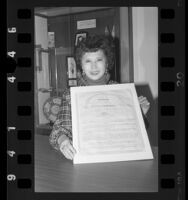 Secretary of State March Fong Eu holding State Constitution at the California State Archives, 1986